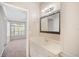 Bright bathroom with white cabinets, a dark framed mirror, and vanity lighting at 10434 Villa View Cir, Tampa, FL 33647