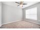 Bright and airy bedroom features neutral carpeting, a ceiling fan and natural light at 10434 Villa View Cir, Tampa, FL 33647