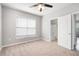 Comfortable bedroom with neutral carpet, ceiling fan and connecting bathroom at 10434 Villa View Cir, Tampa, FL 33647