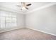 This bedroom features plush carpet, a ceiling fan, and plenty of natural light at 10434 Villa View Cir, Tampa, FL 33647