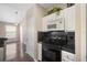Kitchen featuring stylish black appliances, white cabinets and an open layout at 10434 Villa View Cir, Tampa, FL 33647