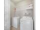 Well-organized laundry room with washer, dryer and ample storage shelving at 10434 Villa View Cir, Tampa, FL 33647