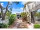 View of backyard showing brick walkway and access to a screened in back porch at 10509 Deepbrook Dr, Riverview, FL 33569