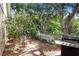 Beautiful backyard featuring stone walkway, mature trees, lush landscaping and stainless steel BBQ grill at 10509 Deepbrook Dr, Riverview, FL 33569