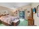 Bright bedroom featuring a ceiling fan, artwork, and sliding glass doors to the outside at 10509 Deepbrook Dr, Riverview, FL 33569