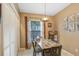 Cozy dining area features natural light, wood table, and tile flooring at 10509 Deepbrook Dr, Riverview, FL 33569