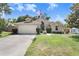 Well-maintained single Gathering home boasts a two-car garage and lush green lawn at 10509 Deepbrook Dr, Riverview, FL 33569