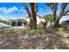 Charming exterior of home with lush landscaping, screened in porch, and mature shade trees at 10509 Deepbrook Dr, Riverview, FL 33569