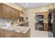 Kitchen featuring granite countertops, tile flooring, and black appliances at 10509 Deepbrook Dr, Riverview, FL 33569