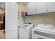 Bright laundry room featuring a washer, dryer, and storage at 10509 Deepbrook Dr, Riverview, FL 33569