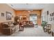 Inviting living room with plush seating, neutral carpet, and lots of sunlight at 10509 Deepbrook Dr, Riverview, FL 33569