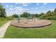 Park includes a classic swing set with multiple swings surrounded by grass, providing a fun recreational area at 10509 Deepbrook Dr, Riverview, FL 33569