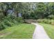 A picturesque walking path with a wooden bridge, lush greenery, and serene nature views in the park at 10509 Deepbrook Dr, Riverview, FL 33569