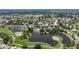 Panoramic aerial view of a golf course community with homes and a lake at 11216 Longbrooke Dr, Riverview, FL 33579
