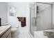 Bathroom features dual vanity, toilet, glass shower doors, and tiled flooring at 11216 Longbrooke Dr, Riverview, FL 33579