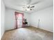 Bedroom featuring neutral walls, ceiling fan, window with pink curtains, and neutral carpeting at 11216 Longbrooke Dr, Riverview, FL 33579