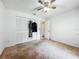 Bedroom features a ceiling fan, closet with folding doors, neutral walls and neutral carpeting at 11216 Longbrooke Dr, Riverview, FL 33579
