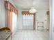 Well-lit dining area featuring a window with ornate curtains and tile flooring at 11216 Longbrooke Dr, Riverview, FL 33579