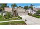 Attractive single-story home with manicured lawn, arched entry, and three-car garage at 11216 Longbrooke Dr, Riverview, FL 33579