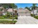 Lovely single-story home with a well-maintained yard, arched entry, and three-car garage at 11216 Longbrooke Dr, Riverview, FL 33579