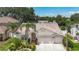 Charming single-story home with a well-manicured lawn, arched entry, and three-car garage at 11216 Longbrooke Dr, Riverview, FL 33579