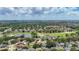 High aerial view of a lush golf course and neighborhoods with blue skies and white clouds at 11216 Longbrooke Dr, Riverview, FL 33579