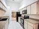 Functional kitchen featuring modern appliances, granite countertops, and white cabinets at 11216 Longbrooke Dr, Riverview, FL 33579