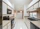 Updated kitchen with black appliances, granite countertops, and a view of the dining area at 11216 Longbrooke Dr, Riverview, FL 33579