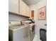 Laundry room features a washer and dryer, overhead cabinets, tiled floor and decor at 11216 Longbrooke Dr, Riverview, FL 33579