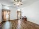 Spacious living room features laminate flooring, neutral walls, a ceiling fan, and large windows at 11216 Longbrooke Dr, Riverview, FL 33579