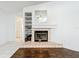 Living room with fireplace, tiled hearth, and built-in shelving, creating a cozy atmosphere at 11216 Longbrooke Dr, Riverview, FL 33579