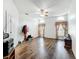 Spacious living room with beautiful laminate flooring, neutral walls, ceiling fan, and two windows at 11216 Longbrooke Dr, Riverview, FL 33579