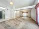 Open-concept living room featuring a cathedral ceiling and large windows at 11216 Longbrooke Dr, Riverview, FL 33579