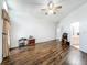 Spacious living room featuring laminate flooring, neutral walls, ceiling fan, and views to the bathroom at 11216 Longbrooke Dr, Riverview, FL 33579