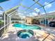 Enjoy a screened-in pool and spa area with an outdoor bar, creating a perfect space for relaxation and entertainment at 11216 Longbrooke Dr, Riverview, FL 33579