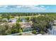 Aerial view of a screened-in pool in a backyard close to mature trees and a golf course at 11216 Longbrooke Dr, Riverview, FL 33579