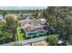 Aerial view of a private screened-in pool surrounded by a white fence and green landscaping at 11216 Longbrooke Dr, Riverview, FL 33579