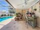 Relaxing screened-in pool area with a bar, ceiling fan and decorative elements create an inviting space for outdoor enjoyment at 11216 Longbrooke Dr, Riverview, FL 33579