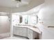 Bathroom features dual sinks, granite counters, white cabinets, and walk-in shower at 11531 Shipwatch Dr # 1030, Largo, FL 33774