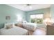 Bright bedroom with two twin beds, a nightstand and natural light at 11531 Shipwatch Dr # 1030, Largo, FL 33774