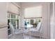 Bright breakfast nook features white wicker chairs and views of the exterior at 11531 Shipwatch Dr # 1030, Largo, FL 33774