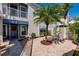 Charming courtyard with brick pavers, tropical foliage, and patio table and chairs at 11531 Shipwatch Dr # 1030, Largo, FL 33774