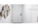 Clean and modern entryway with decorative mirror art and a neutral color palette at 11531 Shipwatch Dr # 1030, Largo, FL 33774