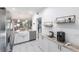Bright kitchen featuring white cabinets, stainless steel appliances, granite counters, and coffee bar at 11531 Shipwatch Dr # 1030, Largo, FL 33774