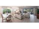 Open-concept living room features neutral decor and large glass doors to the patio and outdoors at 11531 Shipwatch Dr # 1030, Largo, FL 33774