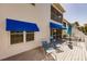 Exterior patio with outdoor seating and blue awnings at 11531 Shipwatch Dr # 1030, Largo, FL 33774