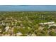 Expansive aerial view showcasing a residential neighborhood with lush green trees and a lake in the distance at 1155 Withlacoochee St, Safety Harbor, FL 34695