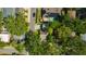 Aerial view showcasing homes and lush greenery, with solar panels and a pool visible on one property at 1155 Withlacoochee St, Safety Harbor, FL 34695
