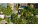 Aerial view of a property highlighted with a red border surrounded by mature trees and neighboring residences at 1155 Withlacoochee St, Safety Harbor, FL 34695