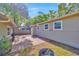 Spacious backyard boasts a brick-paved patio, perfect for entertaining, with mature trees and outdoor lighting at 1155 Withlacoochee St, Safety Harbor, FL 34695